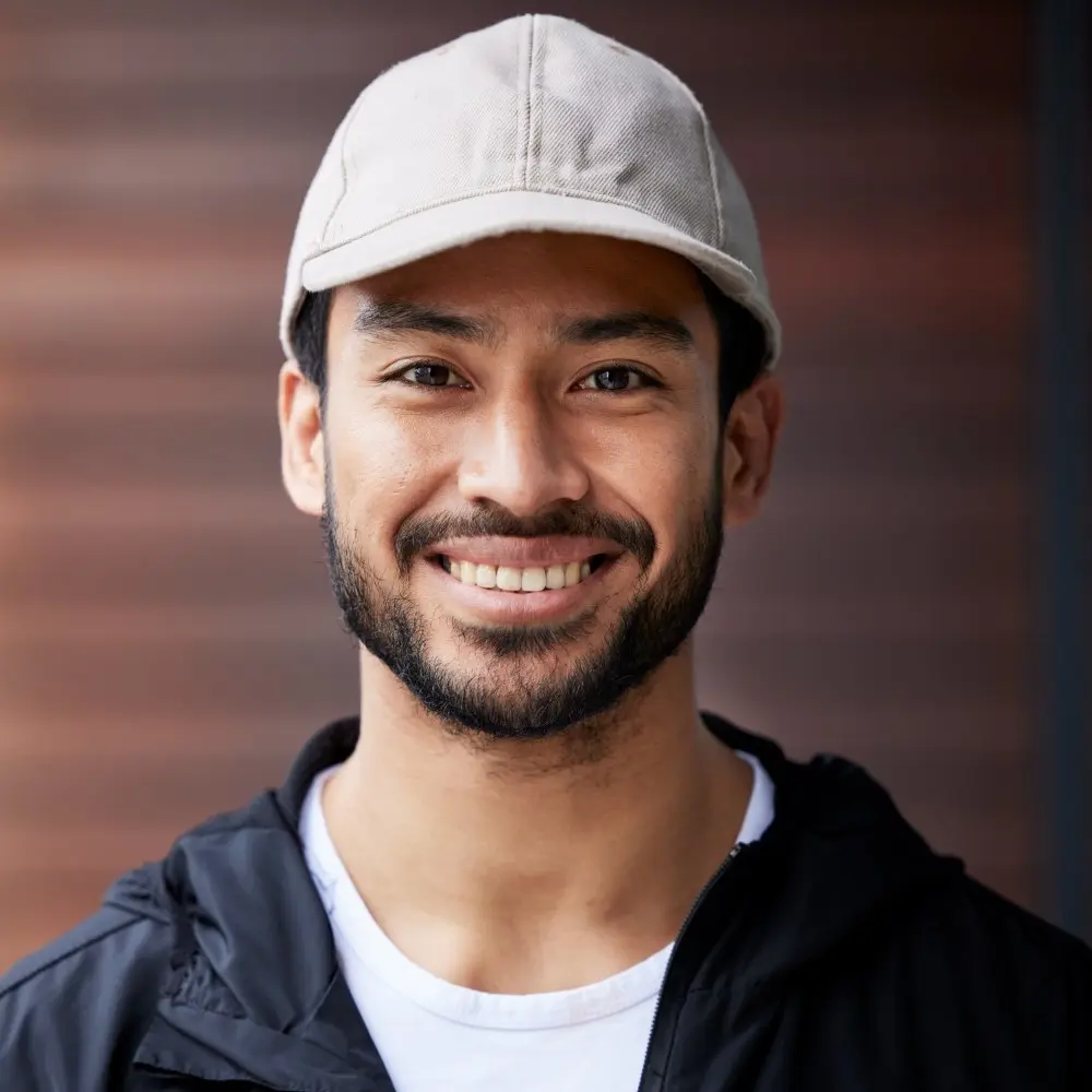 this is a man with white cap and blue shirt