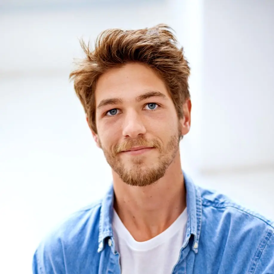 this is a man with blue shirt and green eyes